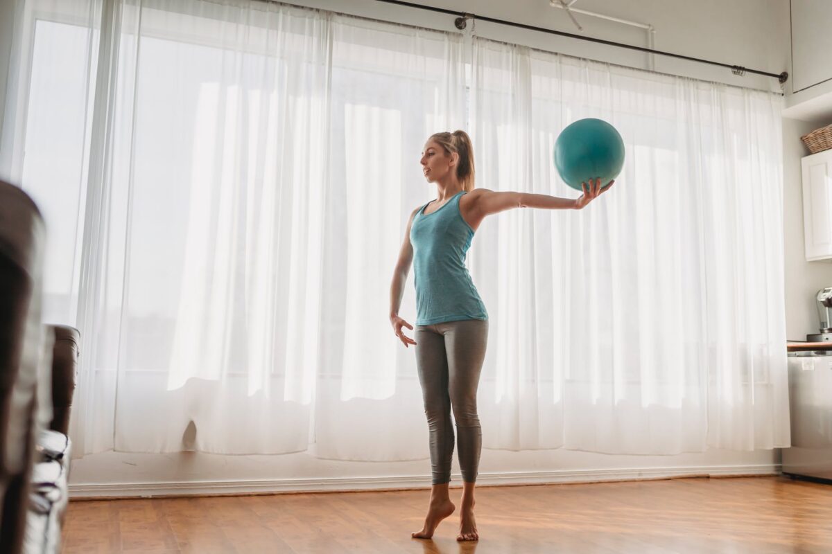 slim woman doing exercises with fit ball